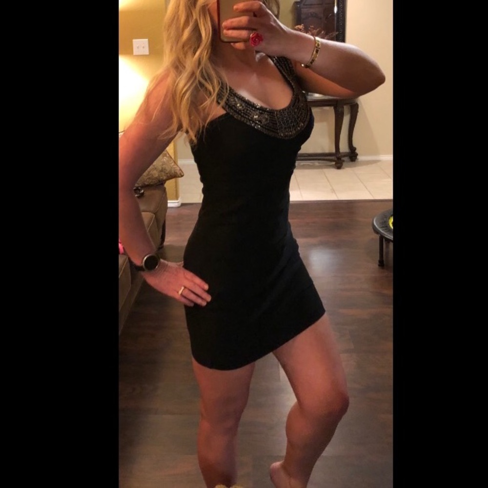 Little black dress with beaded neckline.